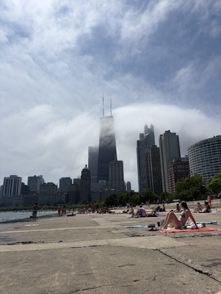 Chicago lakefront beach with skyline and John Hancock tower in clouds
